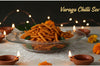 Bowl of Varagu Chilli Sev with decorative elements on a dark background